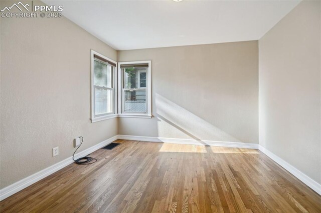 107 N Logan Ave, Colorado Springs, CO 80909 - unfurnished room featuring baseboards and wood finished floors