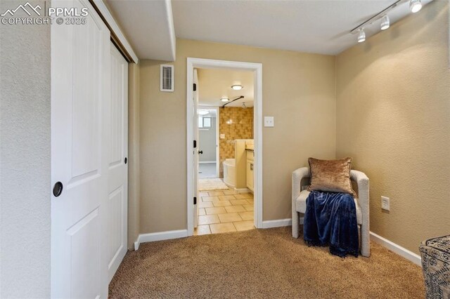 107 N Logan Ave, Colorado Springs, CO 80909 - unfurnished bedroom with carpet floors, tile patterned floors, ensuite bathroom, track lighting, and baseboards