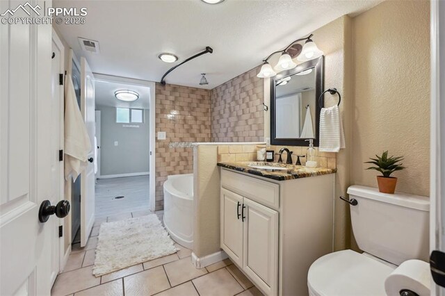 107 N Logan Ave, Colorado Springs, CO 80909 - full bathroom with a bath, vanity, tile patterned floors, and toilet