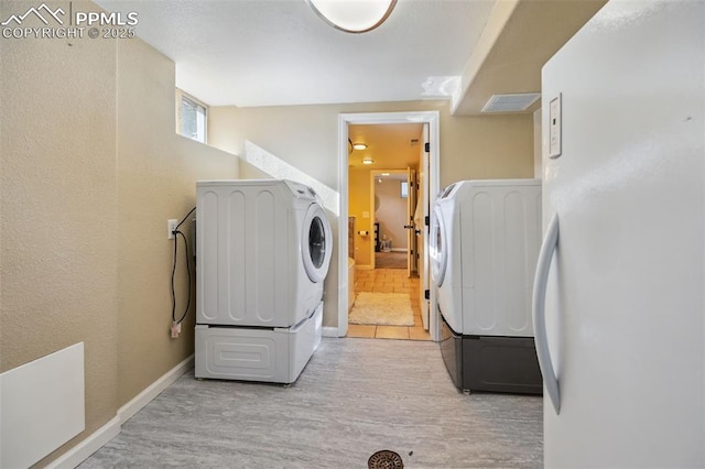 107 N Logan Ave, Colorado Springs, CO 80909 - laundry room featuring washing machine and dryer, wood finished floors, and baseboards