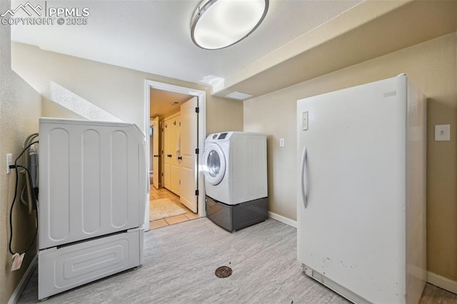 107 N Logan Ave, Colorado Springs, CO 80909 - washroom with light wood finished floors, washing machine and clothes dryer, and baseboards