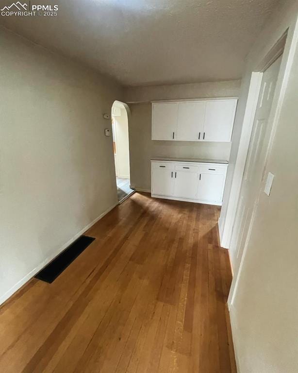 109 Cheyenne Blvd, Colorado Springs, CO 80905 - hallway featuring arched walkways, wood-type flooring, and baseboards