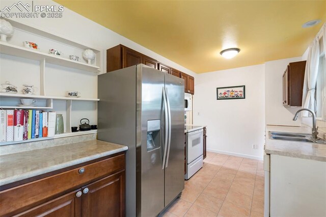 4534 Bella Dr, Colorado Springs, CO 80918 - kitchen featuring white appliances, open shelves, a sink, light countertops, and light tile patterned floors