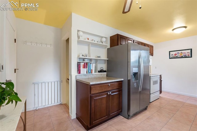 4534 Bella Dr, Colorado Springs, CO 80918 - kitchen featuring stainless steel fridge, electric stove, light tile patterned floors, and light countertops