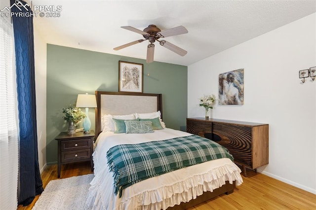 4534 Bella Dr, Colorado Springs, CO 80918 - bedroom with wood finished floors, baseboards, and a ceiling fan