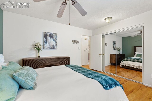 4534 Bella Dr, Colorado Springs, CO 80918 - bedroom with wood finished floors, a closet, a ceiling fan, and baseboards
