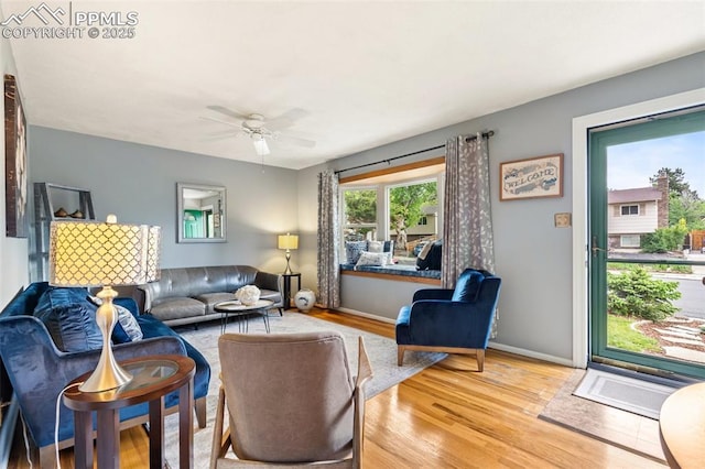 4534 Bella Dr, Colorado Springs, CO 80918 - living room featuring wood finished floors, a ceiling fan, and baseboards