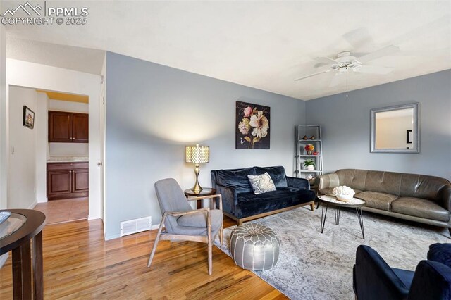 4534 Bella Dr, Colorado Springs, CO 80918 - living area featuring a ceiling fan, light wood finished floors, and baseboards
