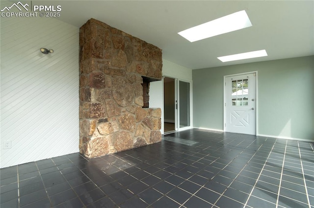 16070 Buggywhip Dr, Elbert, CO 80106 - unfurnished living room with a skylight, tile patterned floors, and baseboards