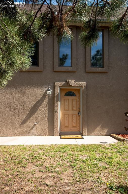 16070 Buggywhip Dr, Elbert, CO 80106 - property entrance with stucco siding