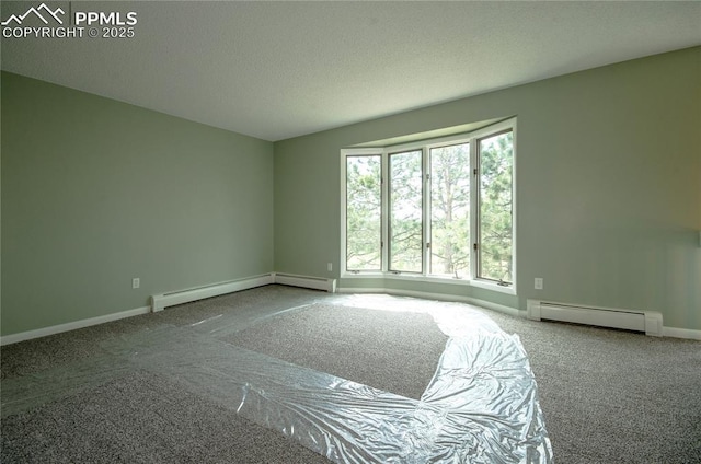 16070 Buggywhip Dr, Elbert, CO 80106 - carpeted spare room featuring baseboard heating, a baseboard heating unit, baseboards, and a textured ceiling