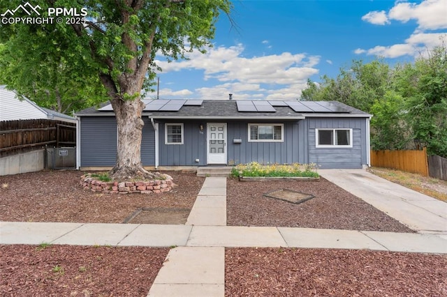 119 Arlen St, Colorado Springs, CO 80909 - view of front facade with board and batten siding and solar panels