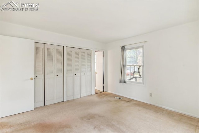 119 Arlen St, Colorado Springs, CO 80909 - unfurnished bedroom with carpet flooring, two closets, and baseboards