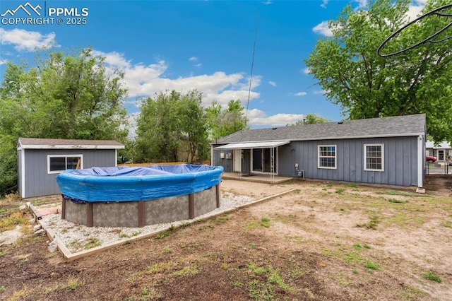 119 Arlen St, Colorado Springs, CO 80909 - rear view of house with a covered pool and board and batten siding