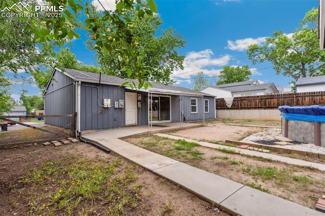 119 Arlen St, Colorado Springs, CO 80909 - back of house with a fenced backyard, a patio area, and board and batten siding