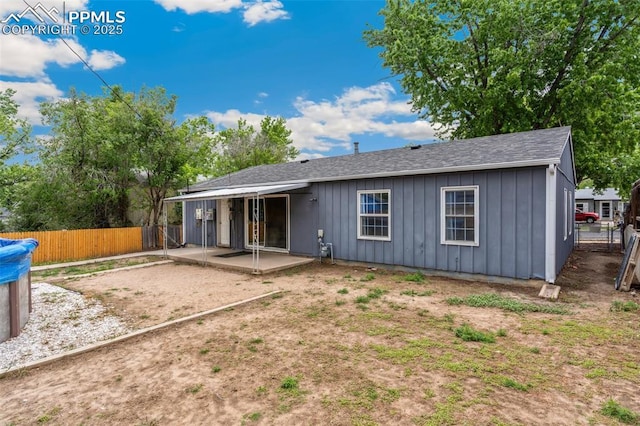 119 Arlen St, Colorado Springs, CO 80909 - rear view of property featuring board and batten siding, a patio area, a fenced backyard, and roof with shingles