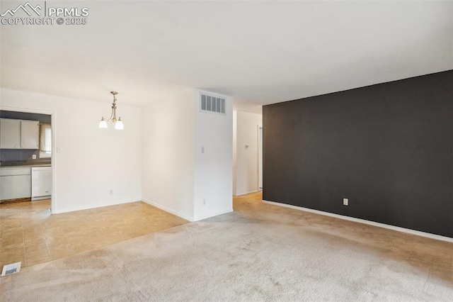 119 Arlen St, Colorado Springs, CO 80909 - empty room with a chandelier, light colored carpet, and baseboards