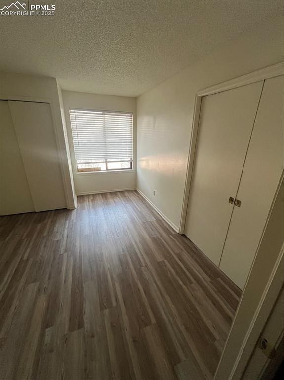 912 Acapulco Ct, Colorado Springs, CO 80910 - unfurnished bedroom with wood finished floors, a textured ceiling, and baseboards
