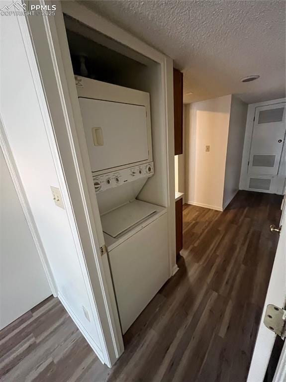 912 Acapulco Ct, Colorado Springs, CO 80910 - laundry room featuring stacked washing machine and dryer, a textured ceiling, and dark wood-style floors