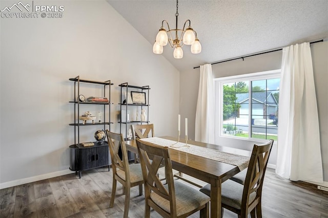 13072 Westlake Pl, Broomfield, CO 80020 - dining area featuring a chandelier, wood finished floors, vaulted ceiling, and baseboards