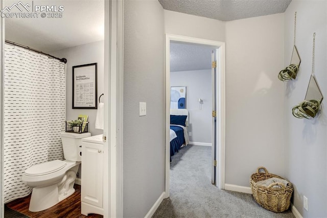 13072 Westlake Pl, Broomfield, CO 80020 - full bathroom featuring toilet, a textured ceiling, curtained shower, and baseboards