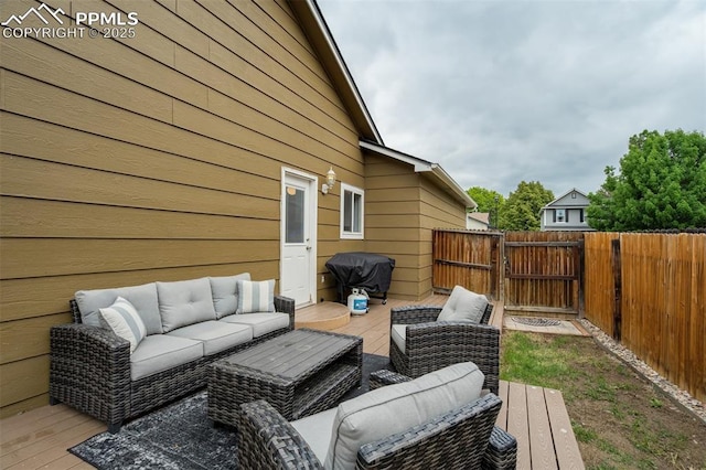 13072 Westlake Pl, Broomfield, CO 80020 - wooden deck featuring an outdoor hangout area, a grill, and a gate