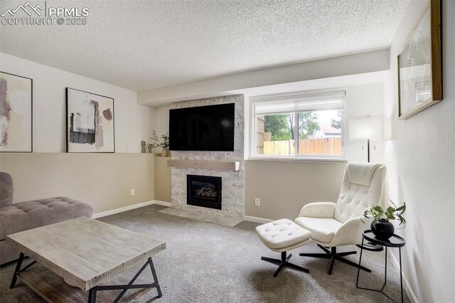 13072 Westlake Pl, Broomfield, CO 80020 - living area with carpet, a textured ceiling, a fireplace with flush hearth, and baseboards