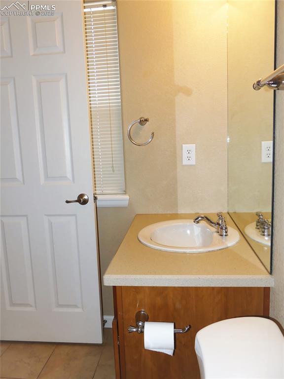 828 S Wahsatch Ave, Colorado Springs, CO 80903 - half bath with vanity, tile patterned floors, and toilet