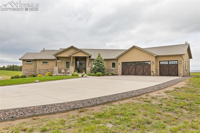 4808 Silver Nell Dr, Colorado Springs, CO 80908 - view of front of property with stone siding, driveway, an attached garage, and stucco siding