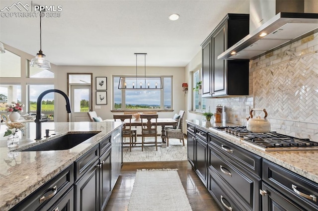 4808 Silver Nell Dr, Colorado Springs, CO 80908 - kitchen featuring a sink, wall chimney range hood, appliances with stainless steel finishes, plenty of natural light, and recessed lighting