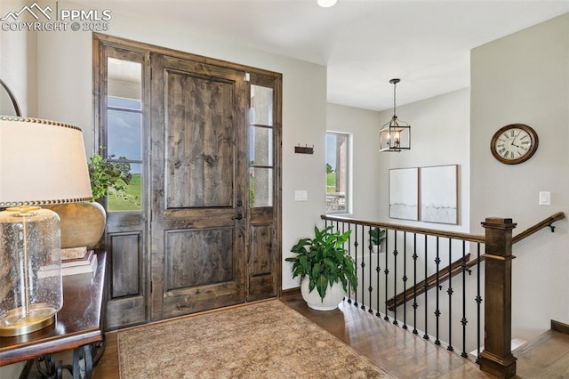 4808 Silver Nell Dr, Colorado Springs, CO 80908 - foyer with wood finished floors, baseboards, and a chandelier