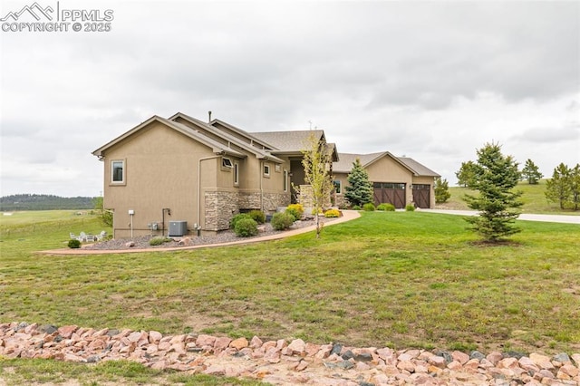 4808 Silver Nell Dr, Colorado Springs, CO 80908 - view of home's exterior with a yard, an attached garage, central AC, and stone siding