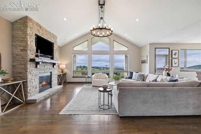 4808 Silver Nell Dr, Colorado Springs, CO 80908 - living area featuring healthy amount of natural light, a chandelier, a fireplace, dark wood-type flooring, and vaulted ceiling