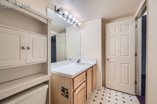 5437 Lions Gate Ln, Colorado Springs, CO 80919 - bathroom featuring tile patterned floors, vanity, and a textured ceiling