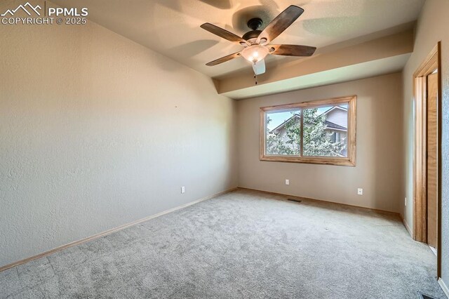 5437 Lions Gate Ln, Colorado Springs, CO 80919 - unfurnished bedroom with light colored carpet, a ceiling fan, and a textured wall