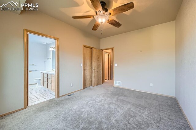 5437 Lions Gate Ln, Colorado Springs, CO 80919 - unfurnished bedroom featuring light carpet, ensuite bath, and a ceiling fan
