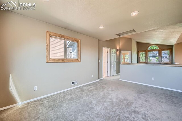 5437 Lions Gate Ln, Colorado Springs, CO 80919 - carpeted spare room with vaulted ceiling, a textured ceiling, and recessed lighting
