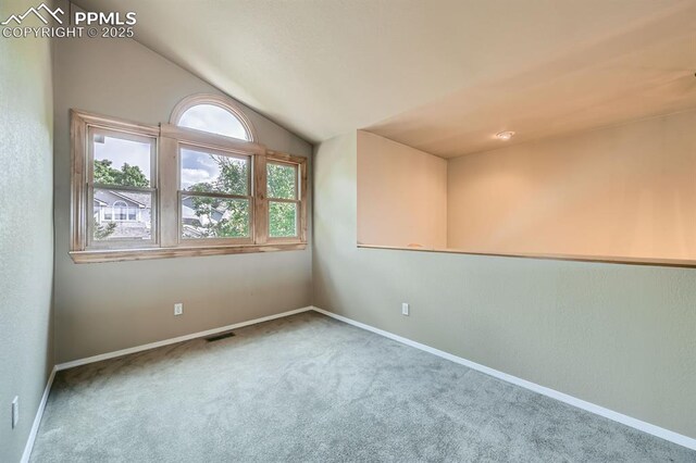 5437 Lions Gate Ln, Colorado Springs, CO 80919 - spare room featuring vaulted ceiling and carpet floors