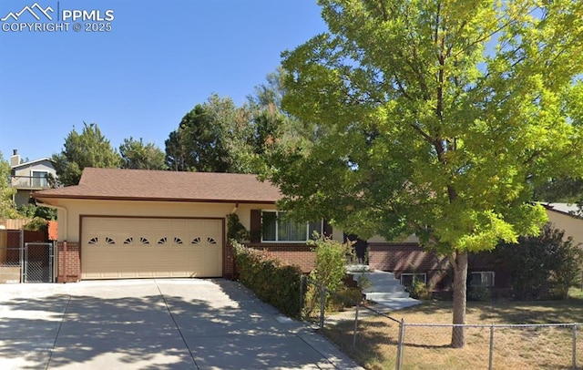1331 Sanderson Ave, Colorado Springs, CO 80915 - view of front of house with driveway, brick siding, and a garage