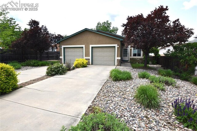 1310-1312 Market St, Colorado Springs, CO 80904 - ranch-style house with stucco siding, driveway, a garage, and stone siding