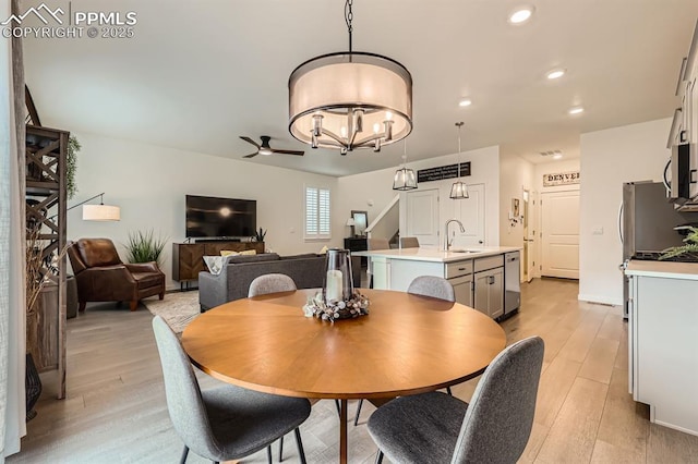 16135 Mountain Flax Dr, Monument, CO 80132 - dining space with light wood-style flooring, ceiling fan, recessed lighting, and a chandelier