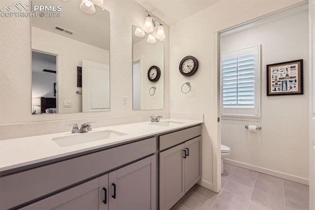 16135 Mountain Flax Dr, Monument, CO 80132 - full bathroom with toilet, double vanity, and baseboards