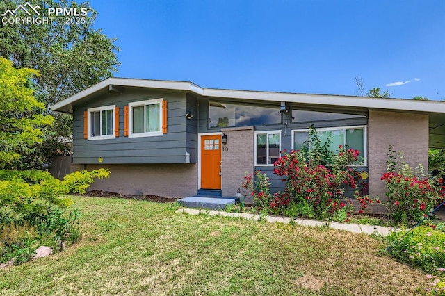 113 Ely St, Colorado Springs, CO 80911 - tri-level home with a front lawn and brick siding