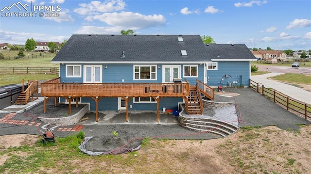 11420 Texarkanna Rd, Peyton, CO 80831 - back of house featuring french doors, a deck, stairs, a patio, and a fenced backyard