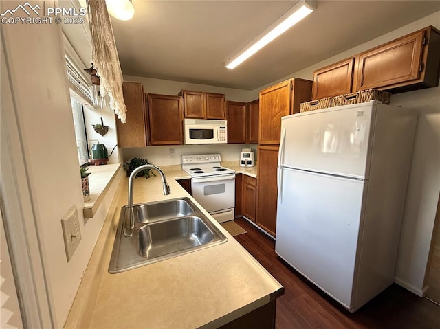 1660 Maitland Ct, Colorado Springs, CO 80919 - kitchen with white appliances, a sink, dark wood finished floors, brown cabinetry, and light countertops