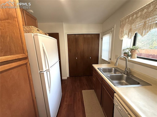 1660 Maitland Ct, Colorado Springs, CO 80919 - kitchen with white appliances, a sink, dark wood-style flooring, light countertops, and brown cabinets