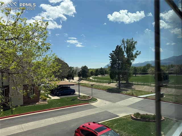 1660 Maitland Ct, Colorado Springs, CO 80919 - view of concrete street with a mountain view and curbs