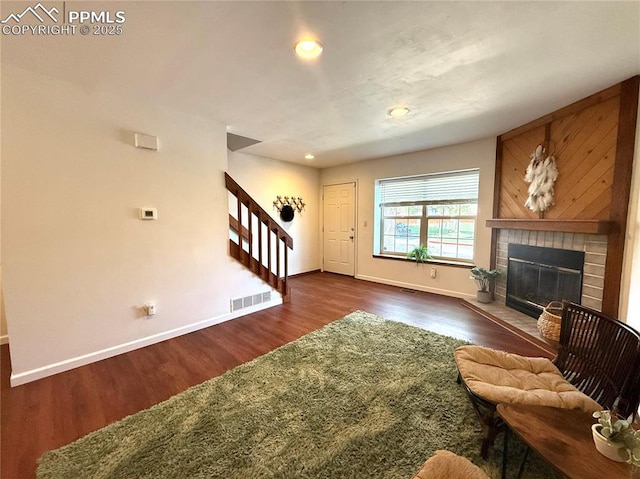 1660 Maitland Ct, Colorado Springs, CO 80919 - living area with baseboards, stairs, dark wood-type flooring, a fireplace, and recessed lighting