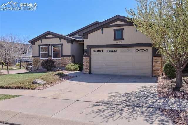 5687 Marshall Creek Dr, Colorado Springs, CO 80924 - ranch-style home with stone siding, stucco siding, driveway, and a garage