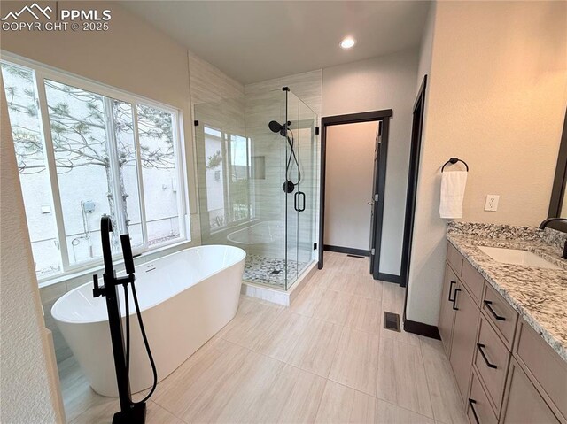 5687 Marshall Creek Dr, Colorado Springs, CO 80924 - bathroom featuring a shower stall, plenty of natural light, a soaking tub, vanity, and recessed lighting